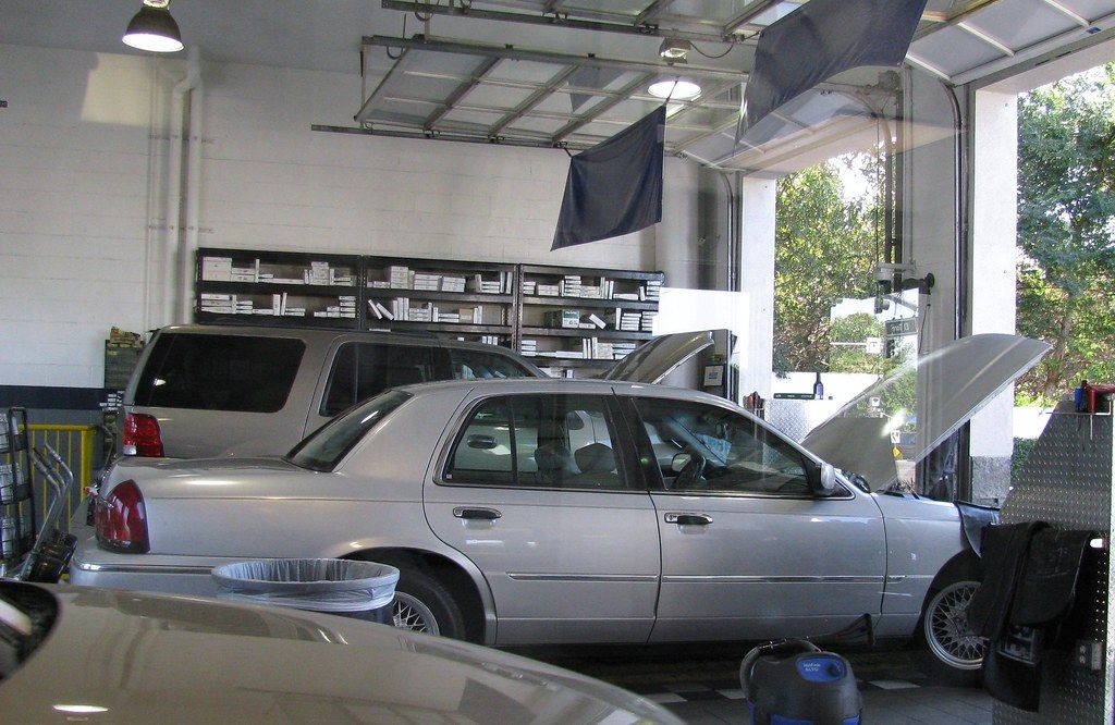 Vehicles parked in the open service bays of an automotive workshop